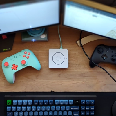 A community image of the Voice Preview Edition n a computer desk featuring a keyboard, mouse, and two game controllers arranged neatly on its surface.